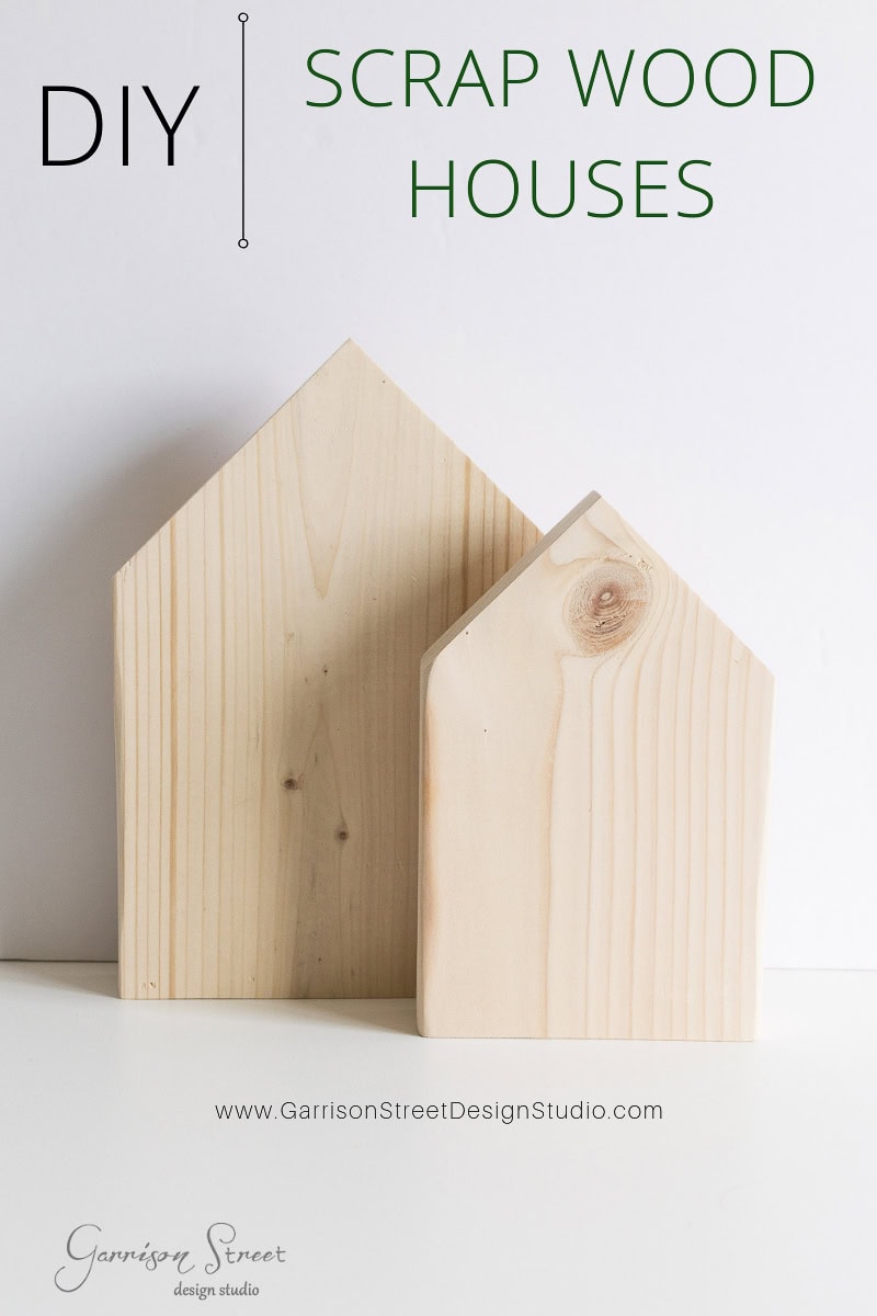 Two wooden block houses stand side by side against a white background. The text reads "DIY Scrap Wood Houses" with a website link. These easy-to-make blocks, perfect for holiday decor, have pointed tops resembling simple house shapes, making them ideal for Christmas displays.