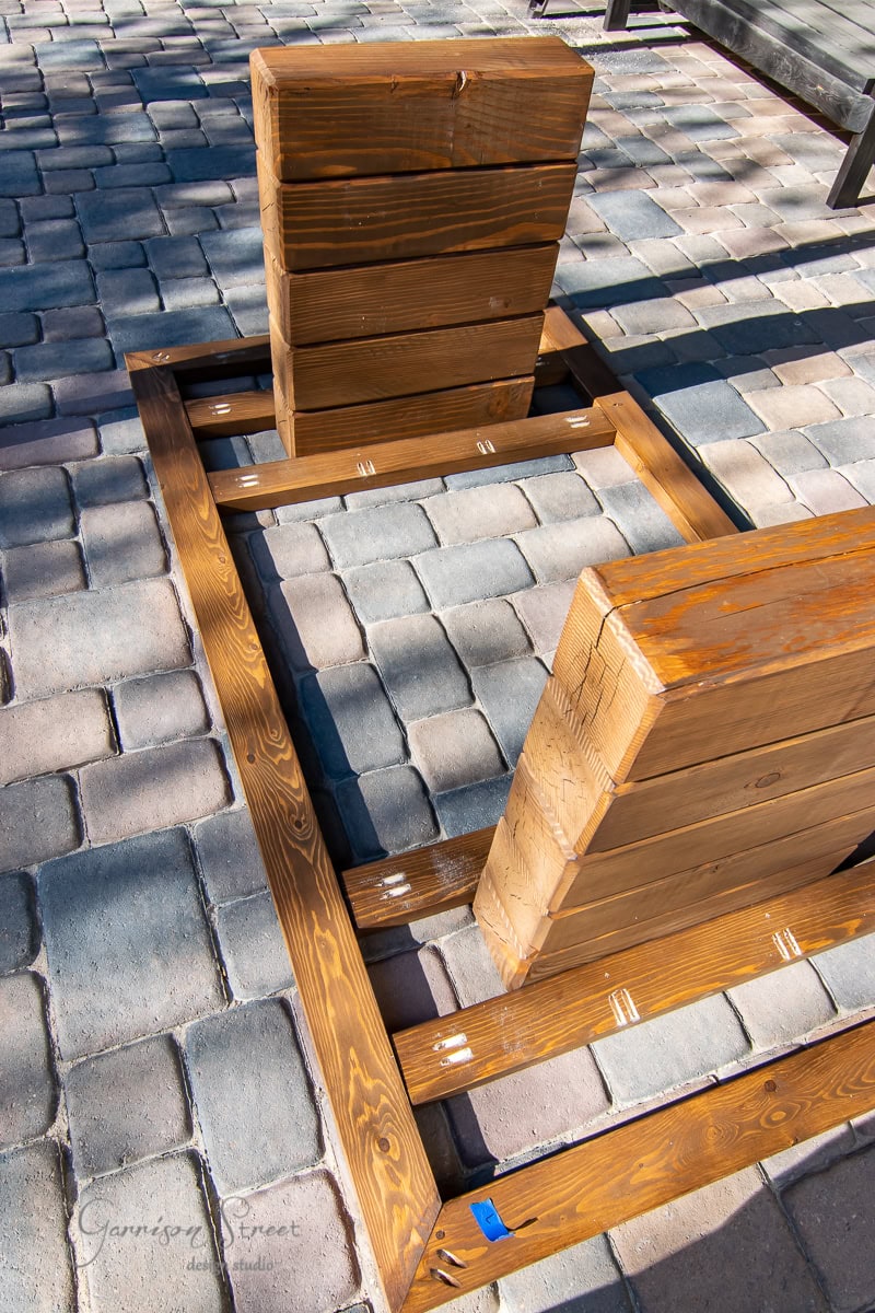 Wooden frames and blocks placed on a stone tile patio.