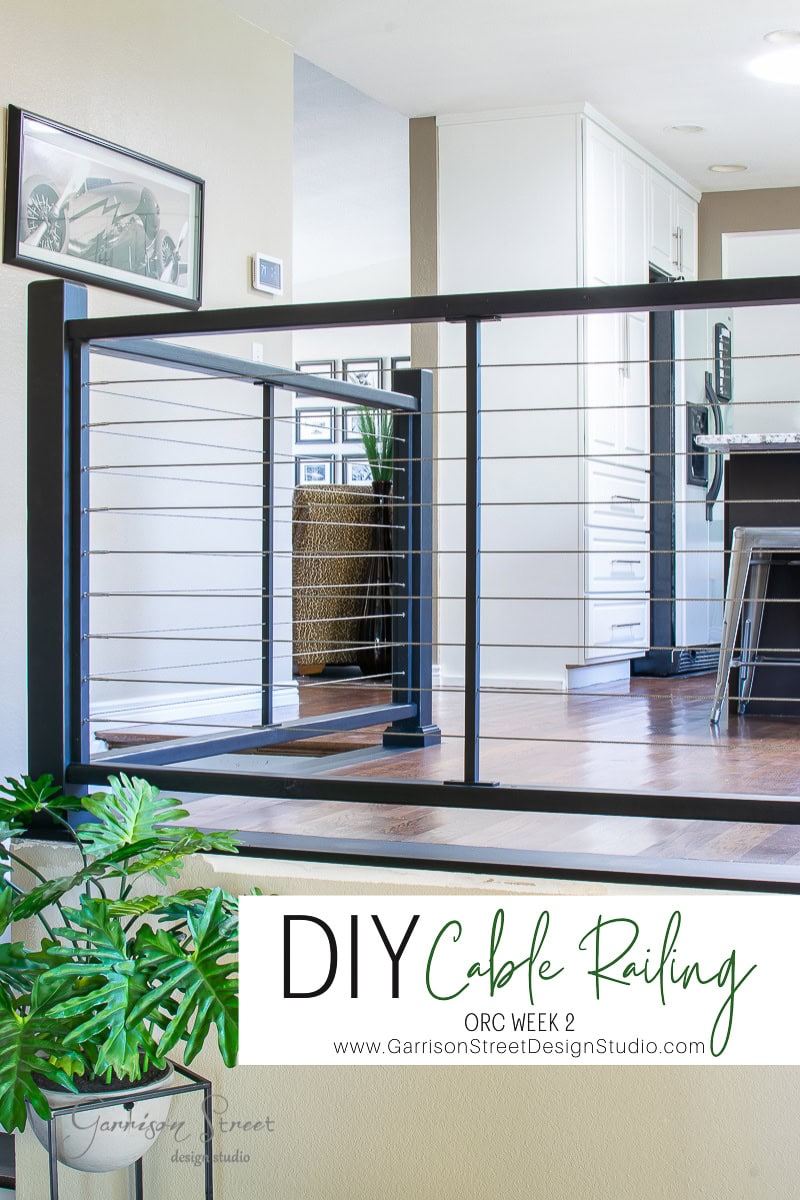 A modern interior highlights a stylish DIY cable railing on the staircase. Light-colored walls and wood flooring create an inviting ambiance, with a glimpse into the kitchen. A plant adds a touch of nature in the foreground. Text below reads, "DIY Cable Railing, ORC Week 2.