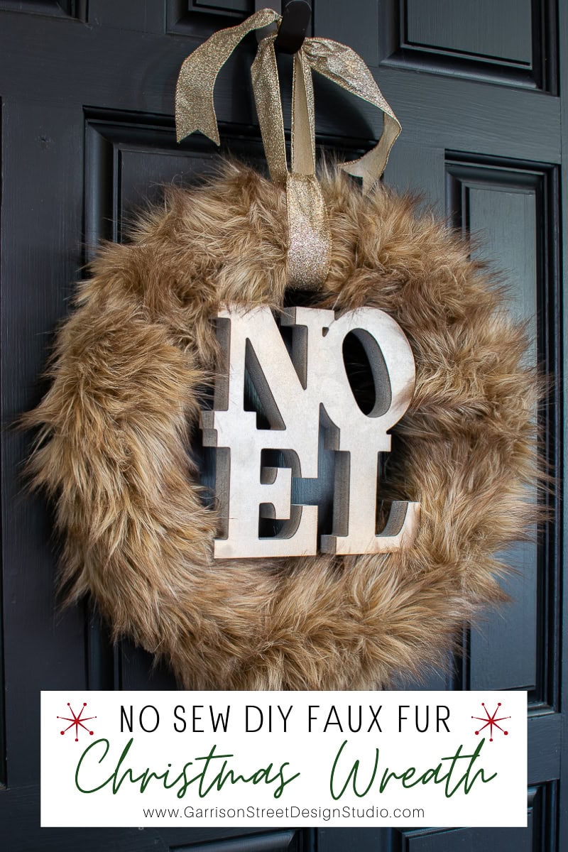 An easy decor idea: a faux fur Christmas wreath with large "N" and "EL" letters spelling "NOEL." Hung on a dark door with a sparkly gold ribbon, it offers festive charm. A small caption reads, "No Sew DIY Faux Fur Christmas Wreath.