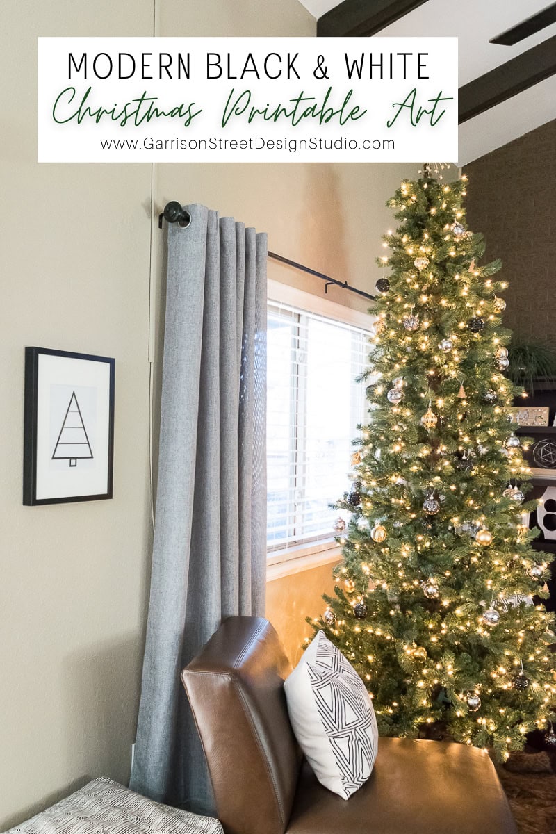 A modern living room showcases elegant Christmas decor, featuring a decorated tree beside a window. A brown chair with patterned pillows sits in front of gray curtains, exuding an easy charm. A minimalist Christmas tree print hangs prominently on the wall.
