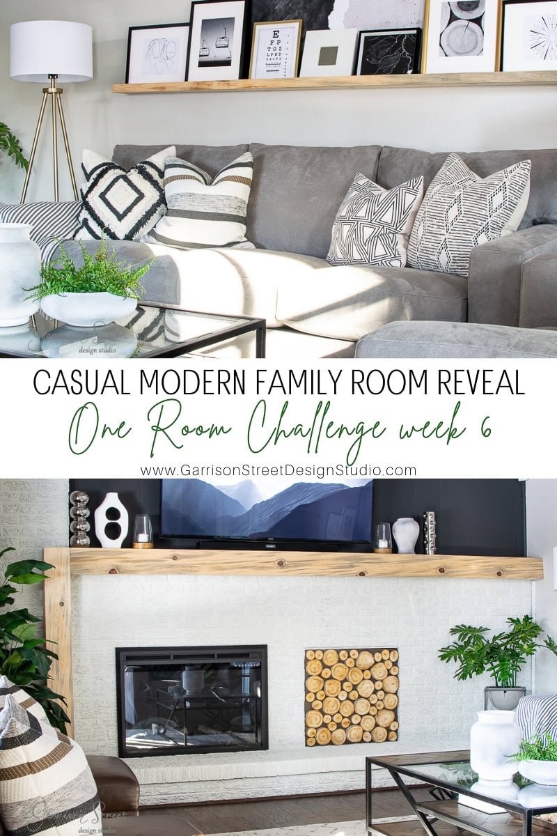 A modern family room features a gray sectional sofa with patterned pillows. A shelf with framed art above complements the space, while a cozy fireplace adorned with stacked logs and potted plants adds warmth. Text reads: "Modern Family Room Reveal.
