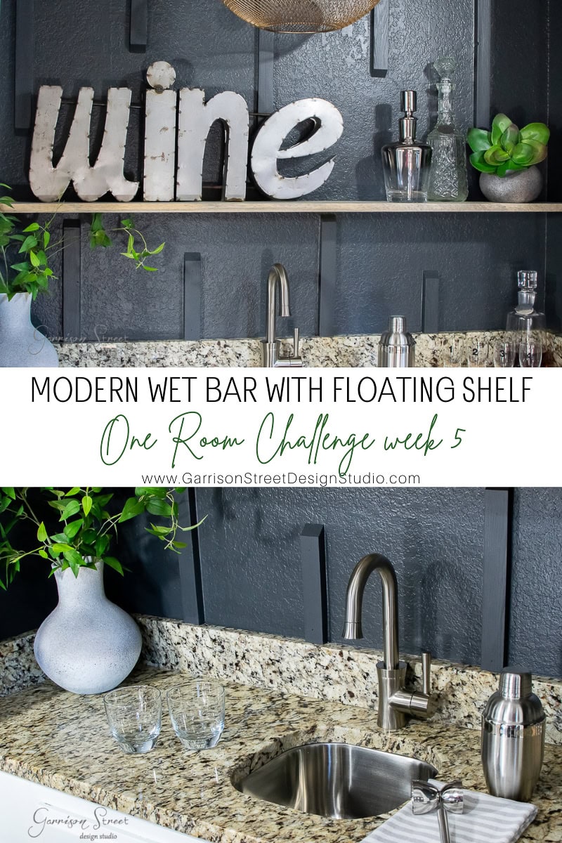 A sleek wet bar with a floating shelf showcases a decorative "wine" sign, a small plant, and a glass container. The bar's granite countertop pairs elegantly with a sink and silver faucet, all set against gray paneled walls that complete this modern oasis.
