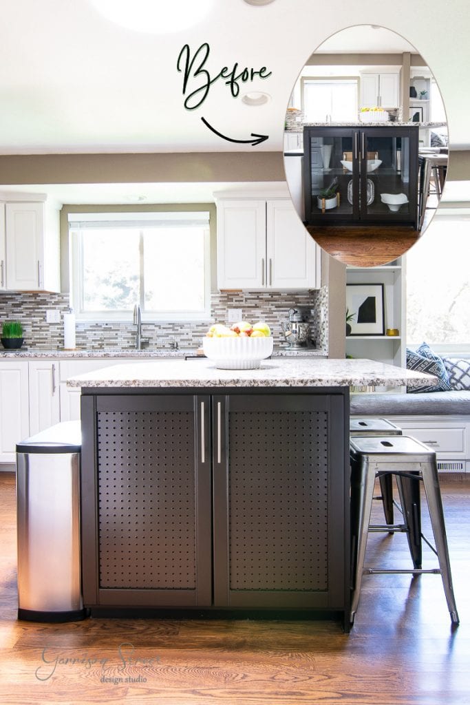A modern kitchen boasts a striking black kitchen island with metal accents and seating, topped with a fruit bowl. Beside it, stylish cabinets enhance the space's allure. The inset shows a "before" image, capturing a remarkable transformation as sunlight floods through the large window behind.