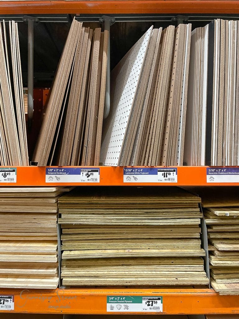 Shelves in a hardware store are stocked with various sizes and types of wooden boards, perfect for crafting a custom kitchen island or cabinet. The labels and price tags are clearly visible, showcasing different options and costs for the materials.