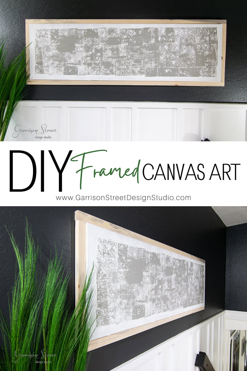 A DIY framed canvas art piece adorns a dark wall, showcasing a textured abstract print in gray and white tones. "DIY Framed Canvas Art" appears as text overlay alongside a website URL. Lush green plants add a touch of nature to the scene, completing the artistic display.