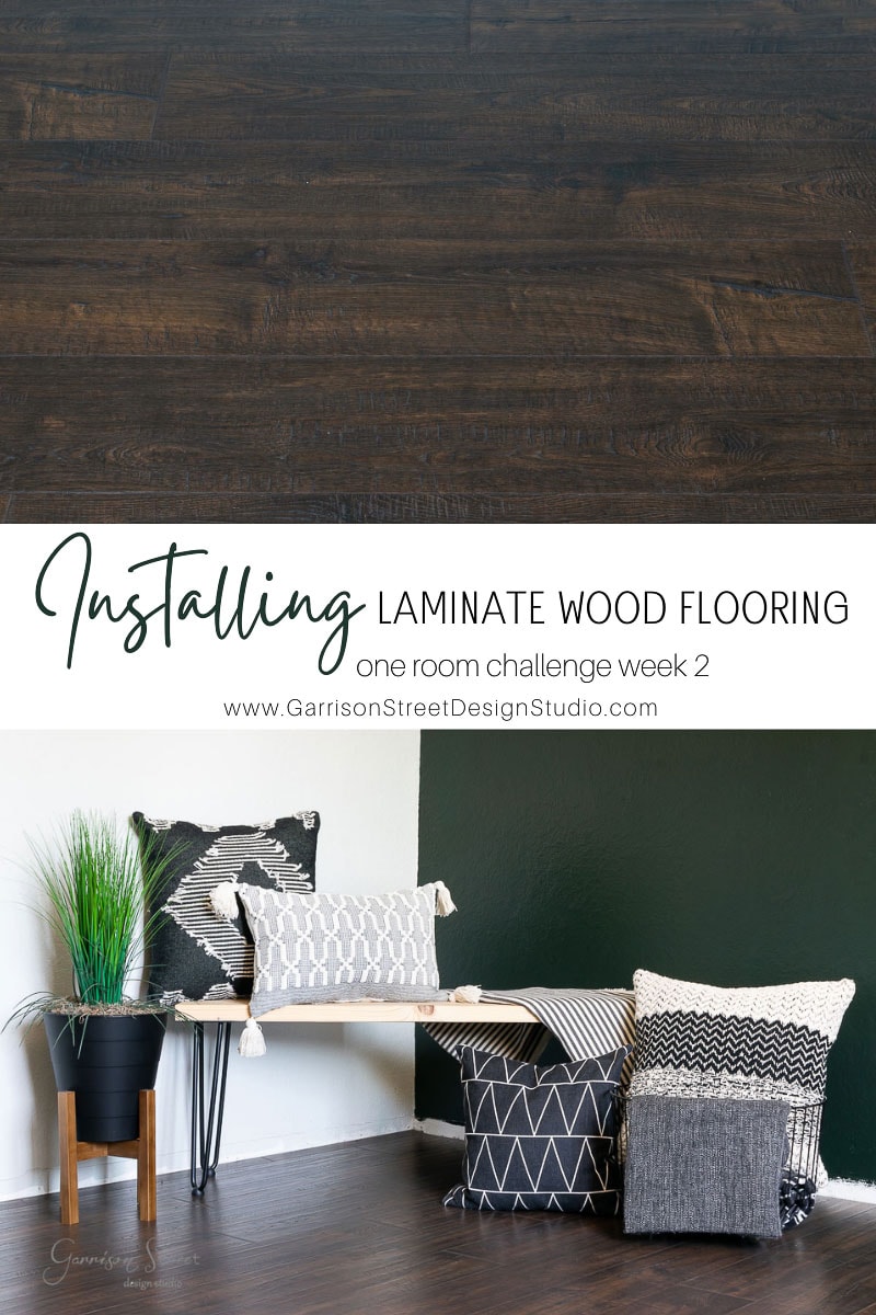 Dark wood laminate flooring sample on top. Below, a cozy corner with a wooden bench, various patterned cushions, a black potted plant, and a green wall. Text reads: "Installing laminate wood flooring for our one-room challenge week 2.