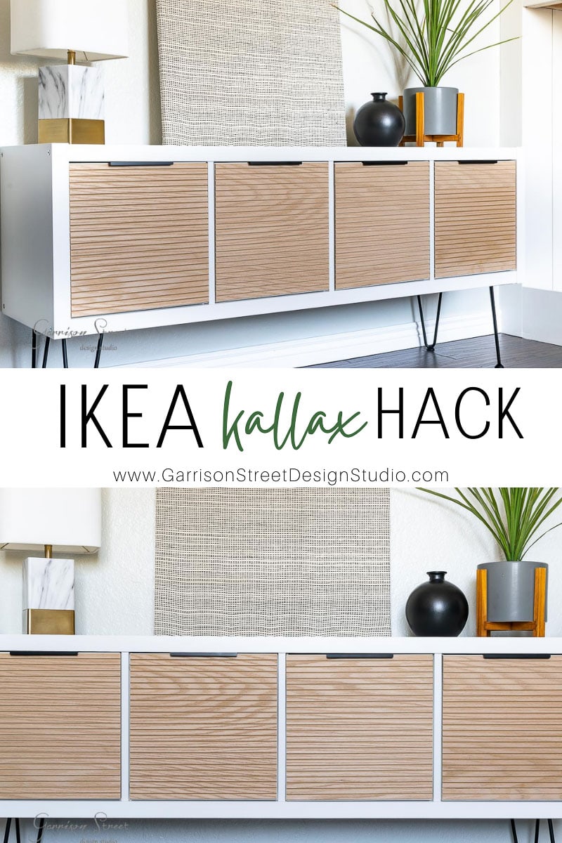 A stylish IKEA Kallax cabinet with wood panel doors graces a modern living room. It features a marble lamp, round mirror, decorative plants, and a book, showcasing an elegant hack by Garrison Street Design Studio.