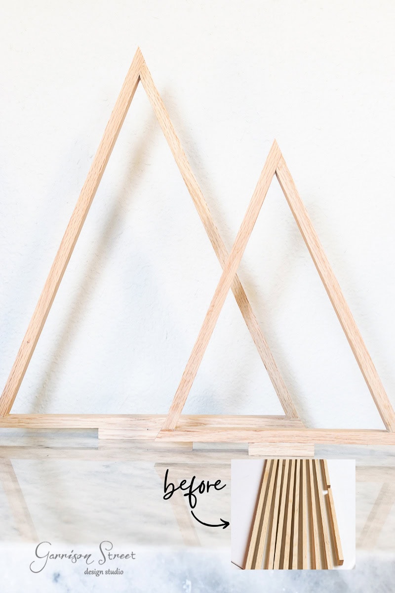 Two wooden triangular frames, reminiscent of scrap wood Christmas trees, stand against a white background. A small inset image at the bottom displays the pieces in their "before" state, laid flat. The text "before," with an arrow, points to this inset image.