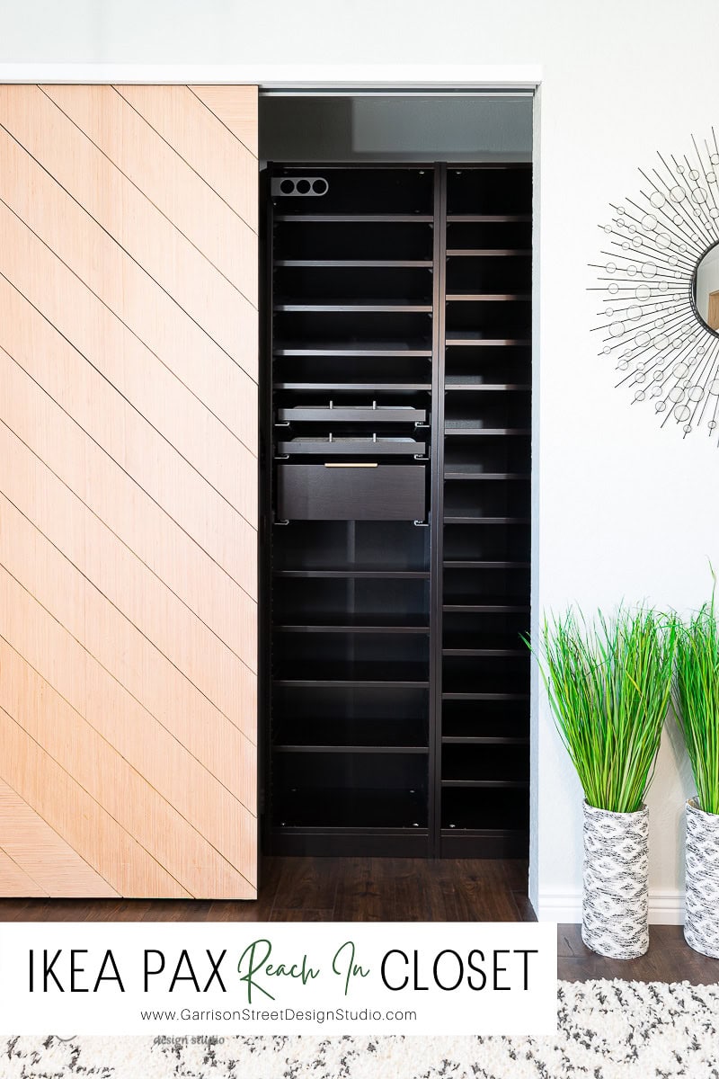 Open closet with black shelves and two light wooden sliding doors, one partially open displaying an empty interior. A round decorative mirror is on the right wall, and two potted plants are on the floor. Text reads: "IKEA PAX Reach-In Closet". The perfect reach-in closet solution for modern homes.