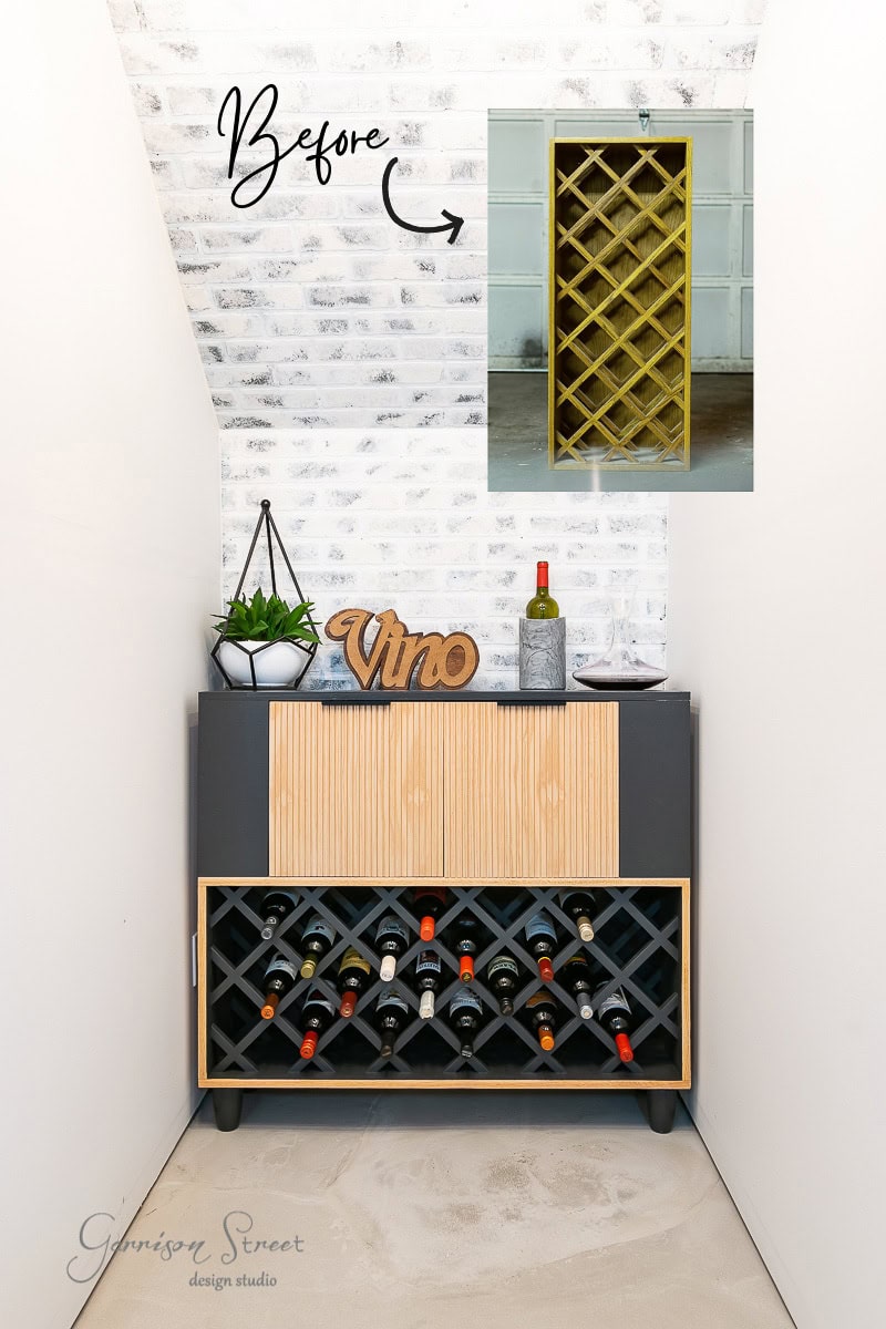 A renovated wine rack display, resembling an IKEA wine bar cabinet hack, stands against a white brick wall. Below, the wooden rack holds bottles, while a "Vino" sign and plant adorn the top. An inset reveals the previous yellow design, highlighting its stylish transformation.