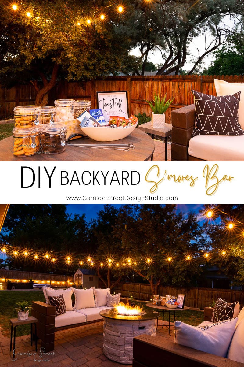 A cozy backyard scene at dusk showcases a delightful DIY s'mores bar, complete with jars of ingredients and a sign reading "Toasted." The seating area by the fire pit, enhanced by string lights, casts a warm glow, inviting all to enjoy this charming backyard s'mores bar atmosphere.