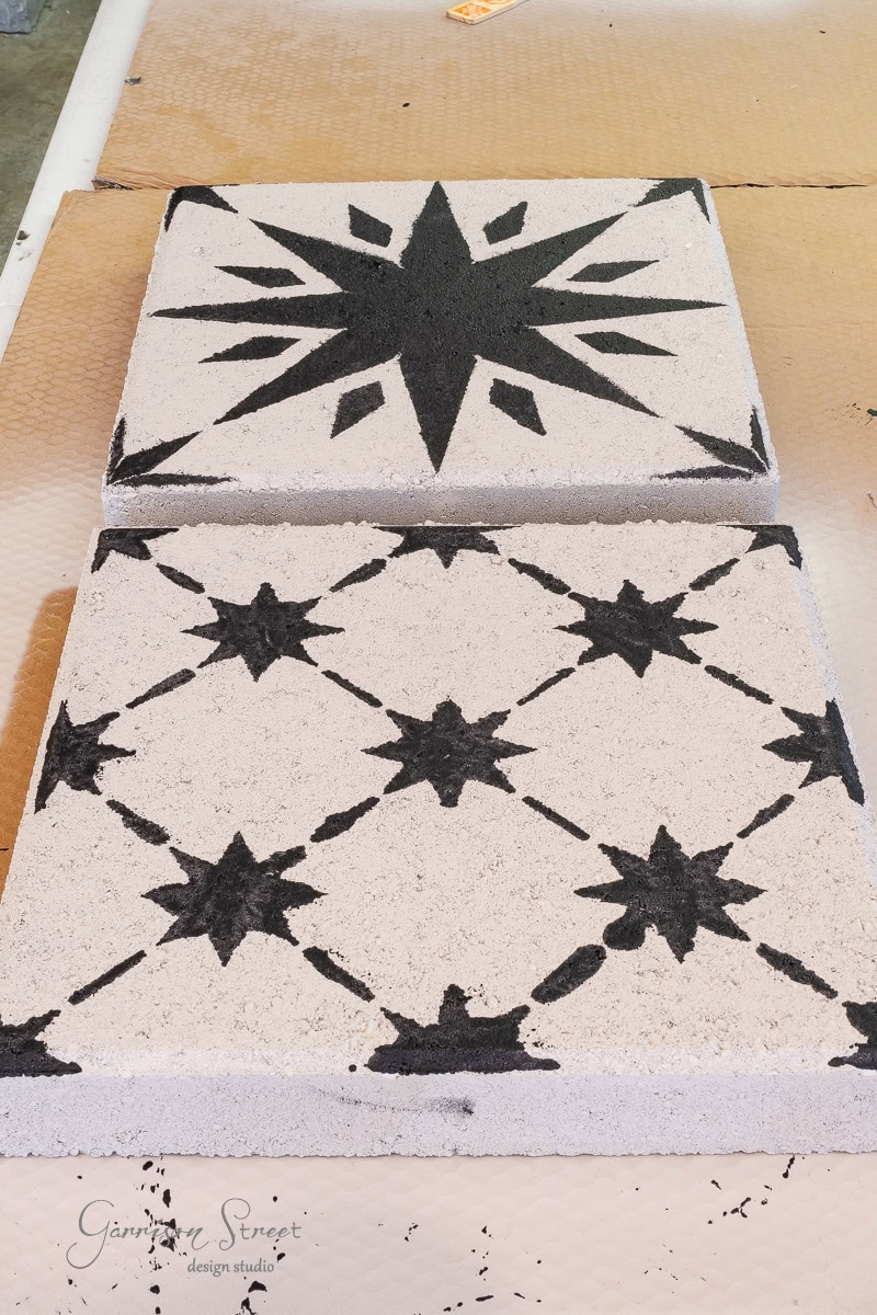 Two concrete pavers are shown with black stenciled star patterns. The top paver features a large star, while the bottom one displays multiple smaller stars in a geometric pattern. The logo in the bottom left corner reads "Garrison Street Design Studio."