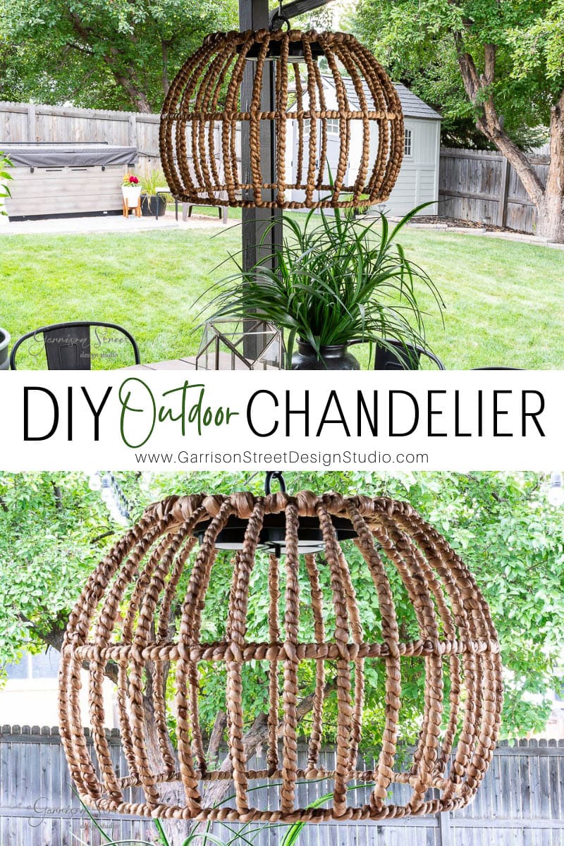 A bohemian-style outdoor chandelier made from woven materials elegantly hangs above a lush green plant, casting a soft glow. The backyard setting features a charming fence and towering trees. Text reads "DIY Outdoor Chandelier" by Garrison Street Design Studio.