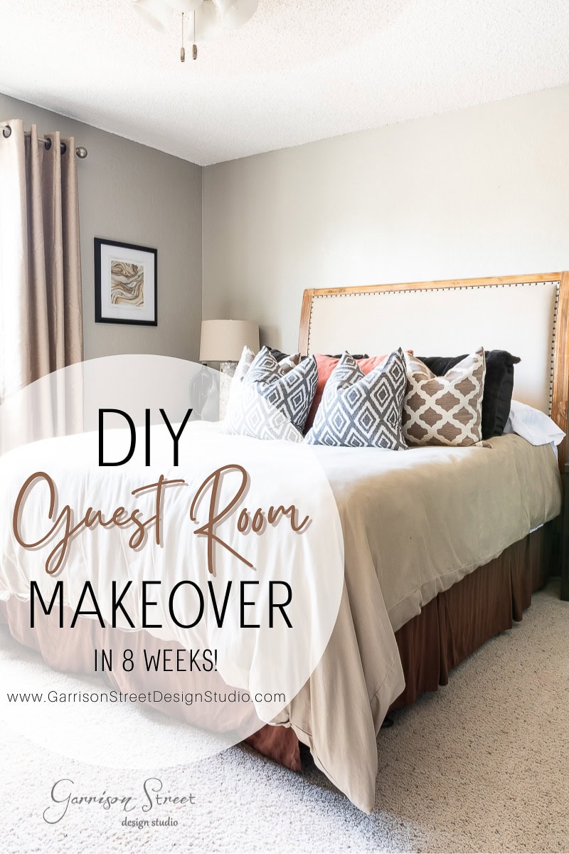 A guest room with a large bed adorned with patterned pillows and a beige comforter exudes charm. A framed picture adds elegance, while curtains frame the window. Text on the image reads, "Bedroom Makeover in 8 Weeks! www.GarrisonStreetDesignStudio.com.