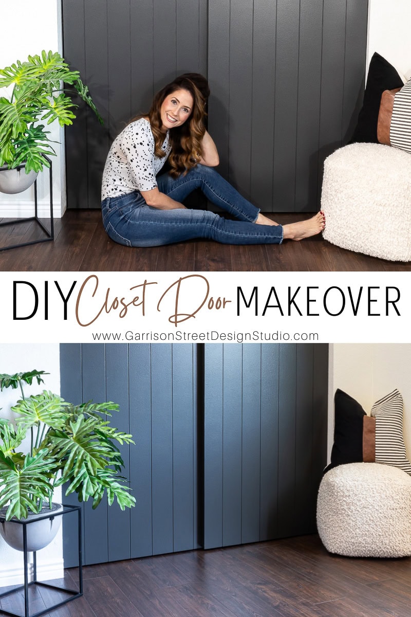 A woman sits on the floor in front of dark closet doors, smiling at her DIY closet door makeover. A large green plant graces the left, while a cozy chair with pillows adds charm to the right.