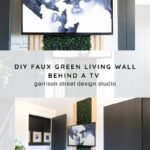 A TV is mounted on a wall with a faux green living wall behind it, framed by light wood panels. The space is modern and bright, styled by Garrison Street Design Studio. Text overlay describes the DIY project.