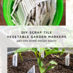 A green bucket filled with white, rectangular tile pieces sits above garden beds using the tiles as plant markers. The text overlay reads: "DIY Scrap Tile Vegetable Garden Markers - garrison street design studio.