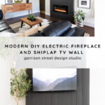 A modern living room features a black shiplap TV wall with an electric fireplace below a mounted TV. Decor includes plants, a wood coffee table, a black sofa, and framed art. Text reads: "Modern DIY Electric Fireplace and Shiplap TV Wall.