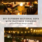 Cozy outdoor patio with a sectional sofa, mattress cushions, fire pit, string lights, and surrounding chairs at night, creating a warm, inviting atmosphere.