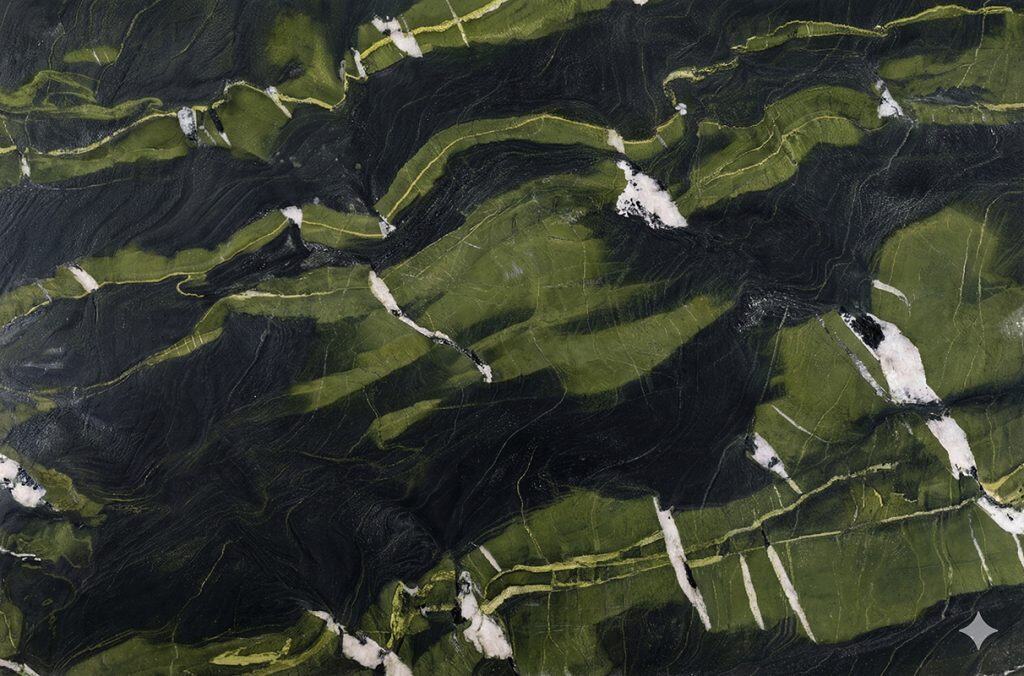 Green marble surface with black and white veining for countertops.