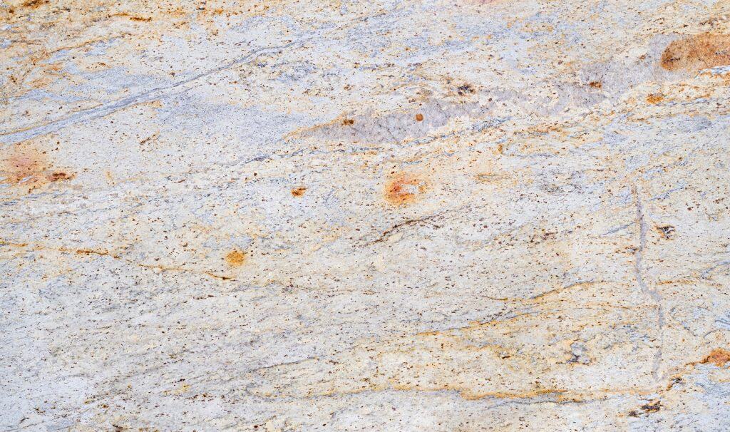 Granite countertop surface with natural stone texture and warm tones. Perfect for kitchen and bathro.