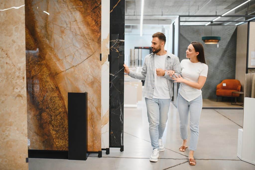 Modern stone countertop in a showroom with a couple exploring the surface.