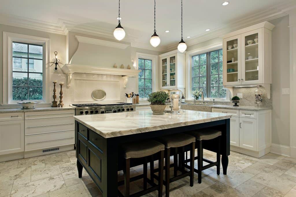 Beautiful kitchen featuring marble countertops and a central island for cooking and dining.