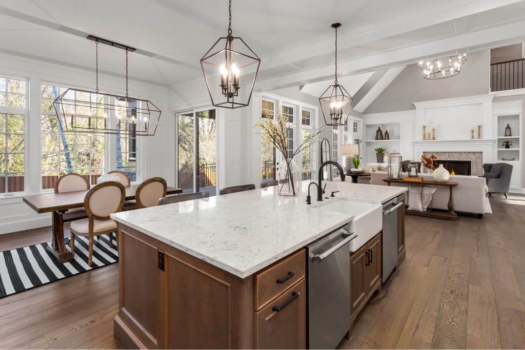 Elegant kitchen with granite countertops and modern lighting.