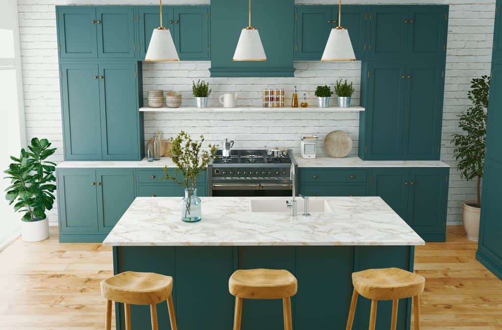 Blue kitchen cabinets with marble countertop and island, perfect for cooking and entertaining.
