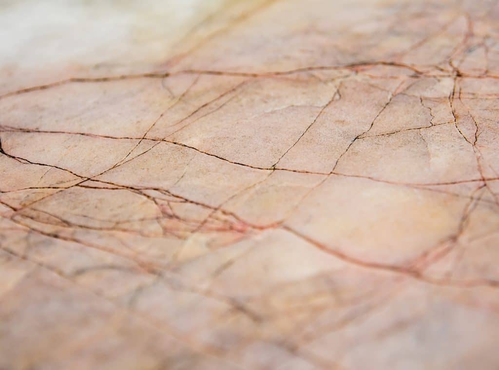 Close-up of natural granite with pink and beige tones and fine veining.