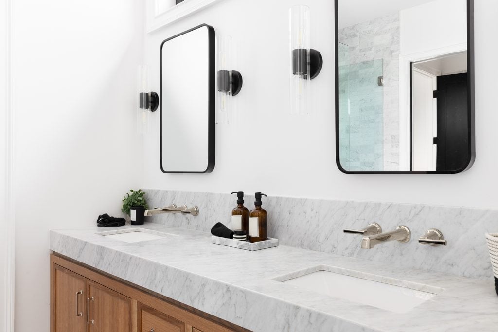 Elegant bathroom vanity with marble countertop and contemporary mirrors for a sleek look.