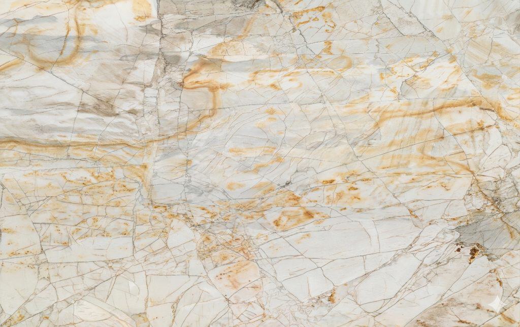 Close-up of a granite countertop with natural stone veining and warm beige tones.