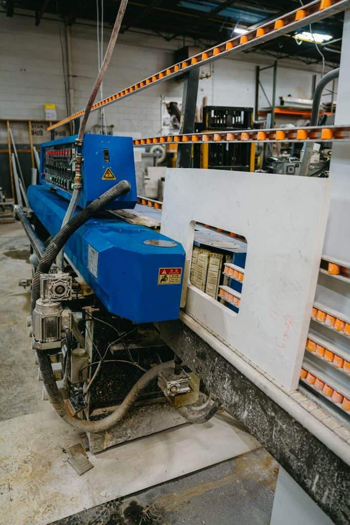 High-precision countertop fabrication equipment in our workshop. Expert craftsmanship for custom gra.