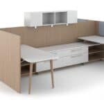 Contemporary office cubicle with white desk, storage drawers, and wall panels.