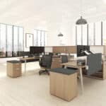 Bright office with large windows, desks, chairs, and plants for a professional workspace.