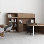 Contemporary office with wooden desk, bookshelf, and seating area.