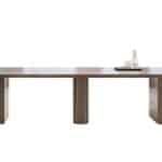 Large conference table with laptop, water pitcher, and glasses.
