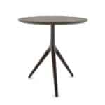 Round wooden table with three angled legs in a modern office setting.