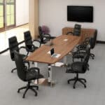 Conference room with large table, chairs, and wall-mounted TV.