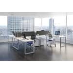 Contemporary office with desks, chairs, and large windows overlooking cityscape.