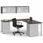 Office desk with chair, laptop, and storage cabinets in a professional workspace.