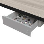 Open office drawer with pens, calculator, and markers inside.
