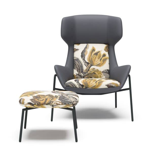 Contemporary lounge chair with high back and floral cushion, with matching ottoman.