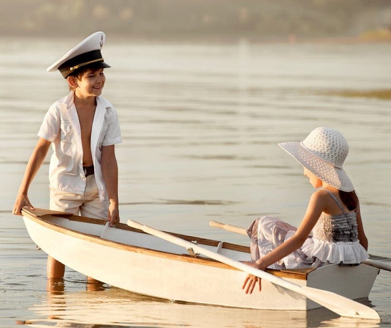 Child and girl enjoying boating at Hall's Sport Center, outdoor water sports, family recreational activities, and boating adventure.