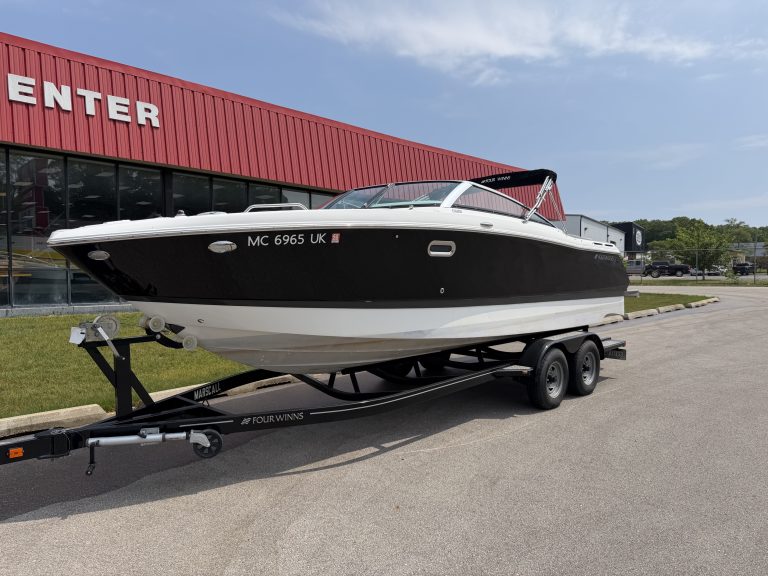 High-quality motorboat displayed on a trailer outside Hall's Sport Center, ideal for water sports an.