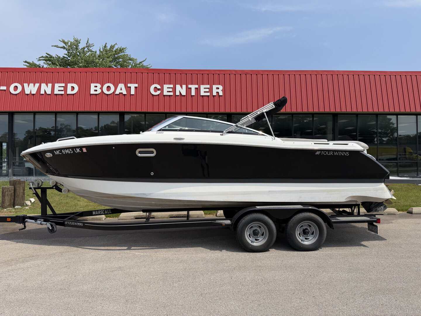 Boat for sale at Hall's Sport Center, featuring a sleek black and white design.