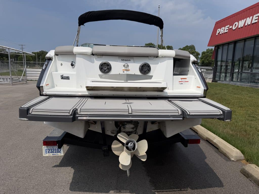 Boat with outboard motor parked outdoors at Hall's Sport Center.