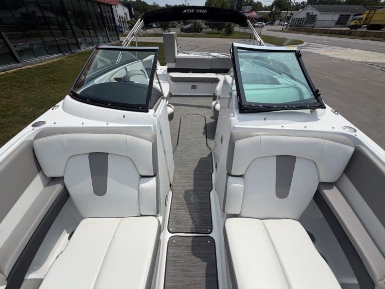 Boat with white seating and black windshield frames at Hall's Sport Center.