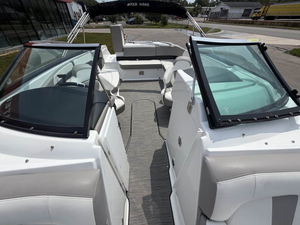 Boat with white seating and windshield, ideal for water sports and leisure activities.